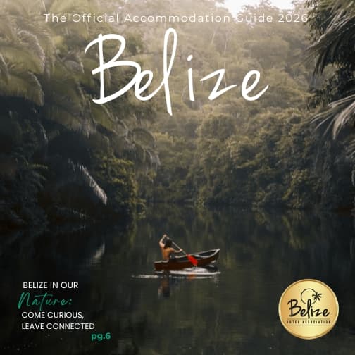 A person paddles a canoe through a lush, green river in Belize.